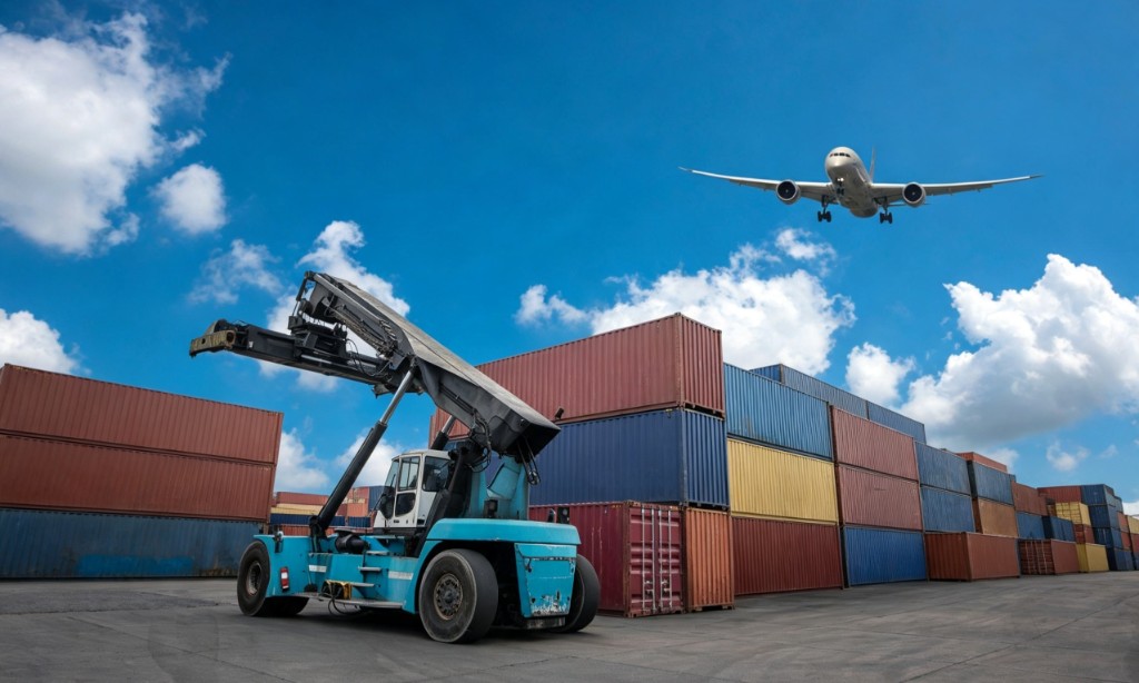 Reach stacker and shipping containers with cargo plane overhead